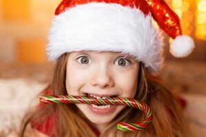 How the Holidays Affect Your Teeth: \Child enjoying holiday treats while maintaining oral health at Muir Station Smiles